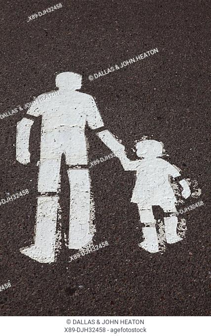 Finland, Helsinki, Helsingfors, Man And Child Walking Sign Painted on Road Surface
