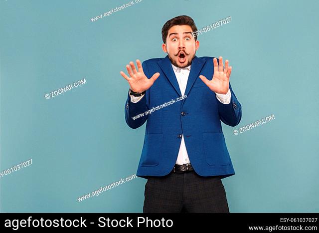 Portrait of man with surprised face. Open mouth and shout. Business people concept, richly and success. Indoor, studio shot on light blue background