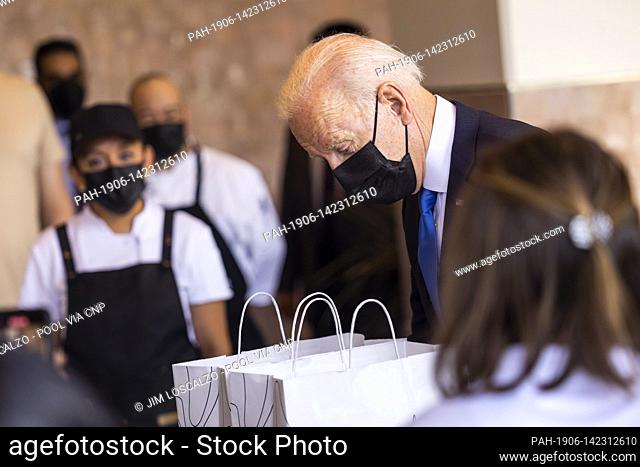 United States President Joe Biden picks up tacos during a visit to Las Gemelas Restaurant in Washington, DC, USA, 05 May 2021