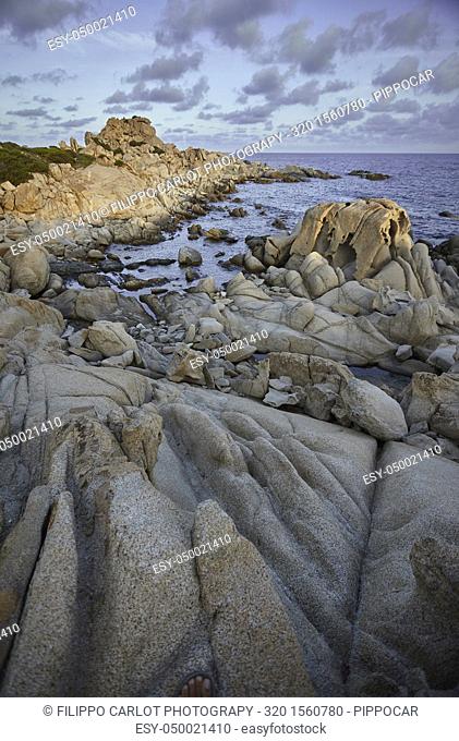 Beautiful cliff on the southern coast of Sardinia, formed by granite rock shaped by the sea and the elements. Vertical Shot
