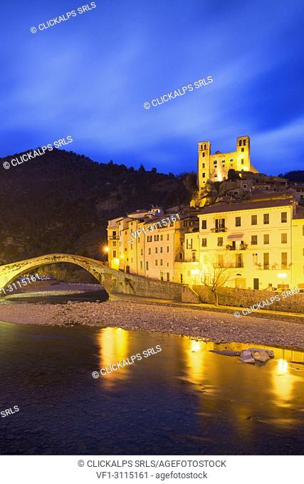 The lights are reflected in the river during twilight. Dolceacqua, Province of Imperia, Liguria, Italy, Europe
