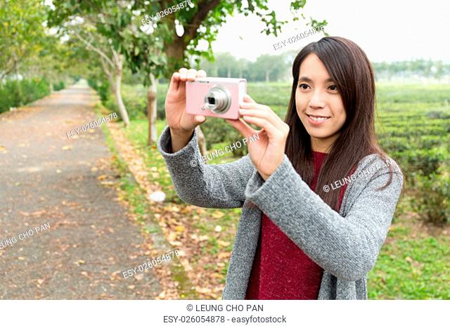 Asian Woman taking picture for landscape