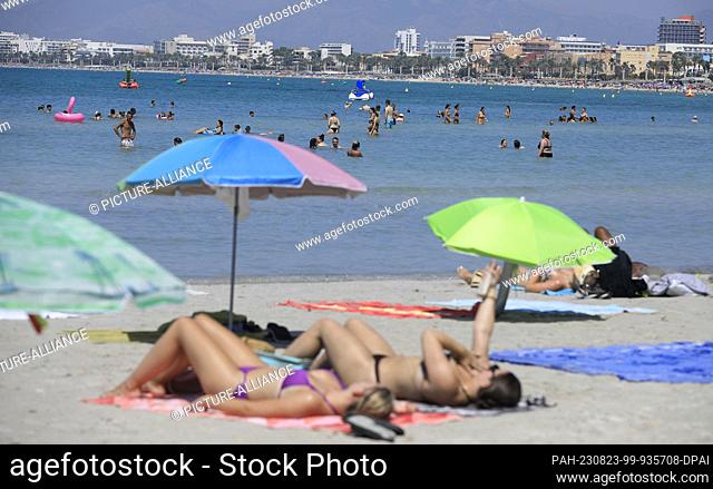 23 August 2023, Spain, Palma: People spend a summer day on the beach Arenal. Spain is experiencing the fourth official heat wave of this year's summer