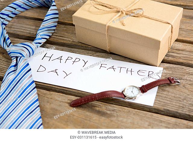 High angle view of fathers day greeting by gifts