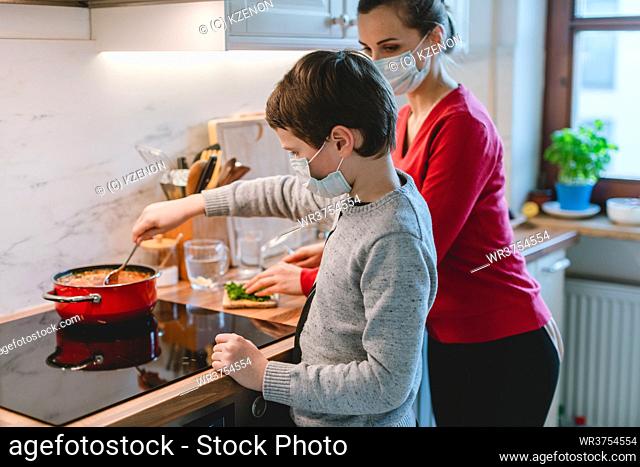 Family cooking at home in kitchen during coronavirus crisis