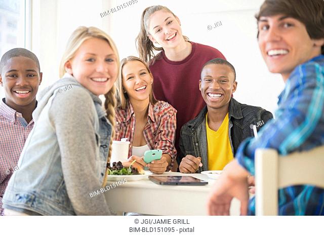 Teenagers smiling at table