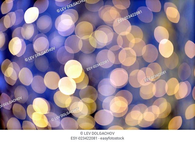christmas, holidays and background concept - blurred blue and golden lights bokeh