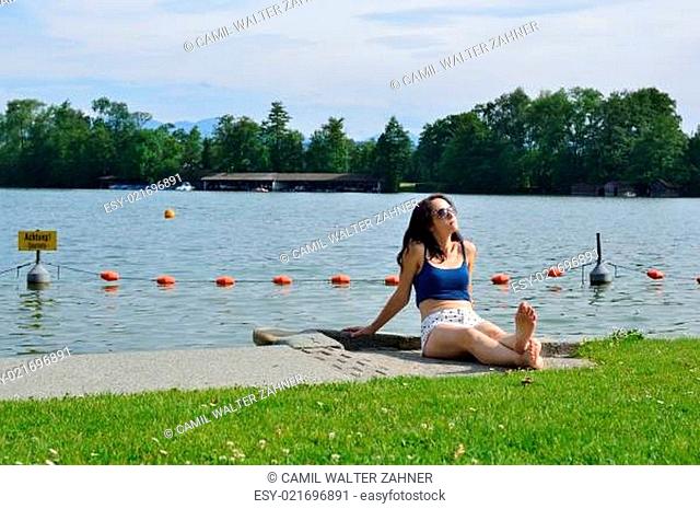 Woman tanning on the lake