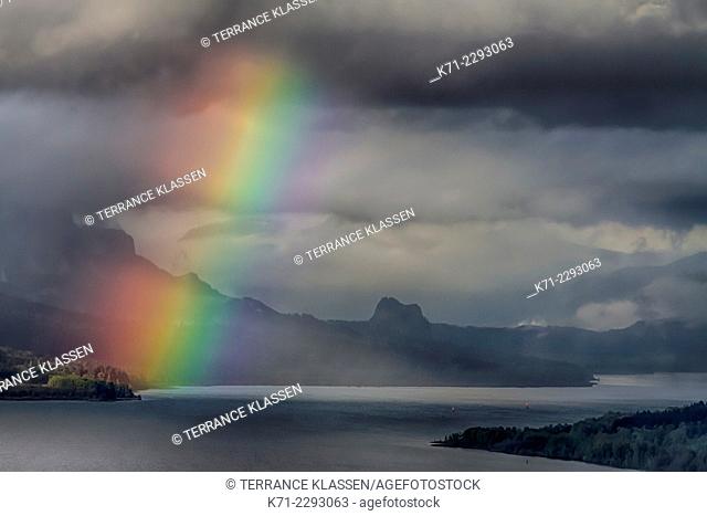 A view down the Columbia River gorge with a rainbow near sunset, Oregon, USA