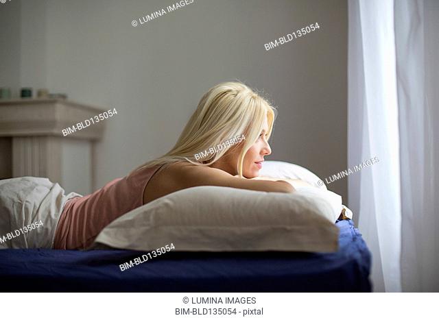 Caucasian woman laying in bed