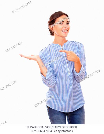 Portrait of 30-34 years pretty woman holding her right palm up while pointing to her right hand and smiling at you on isolated white background - copyspace