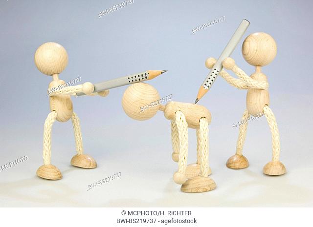 two wooden figures attacking a third with pencils