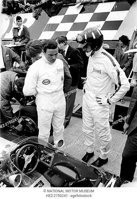 Jim Clark and Graham Hill in pits with Lotus 49 during 1967 British Grand Prix. Creator: Unknown