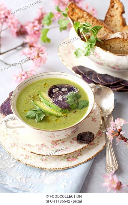 A Bowl of Spring Green Soup with Avocado and Beet Chips