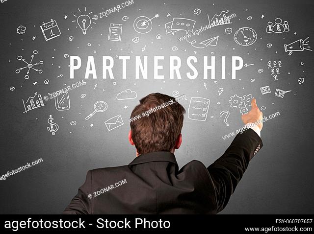 Rear view of a businessman with PARTNERSHIP inscription, modern business concept