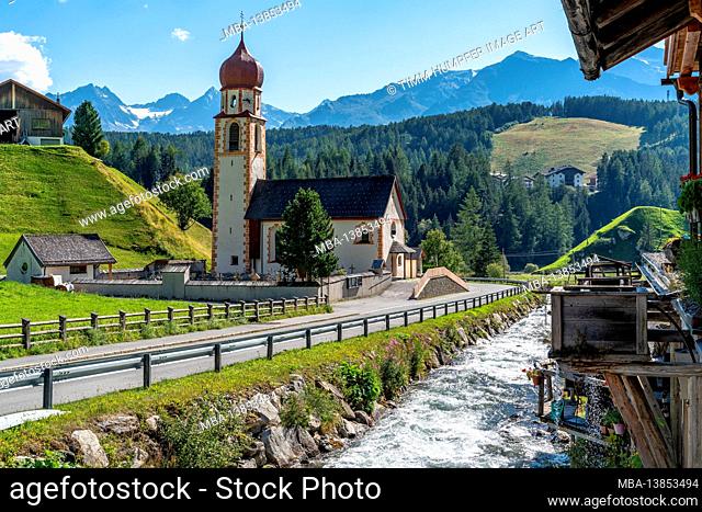 Europe, Austria, Tyrol, Ötztal Alps, Ötztal, Niederthai, view of the parish church of Saint Antonius and the old village smithy