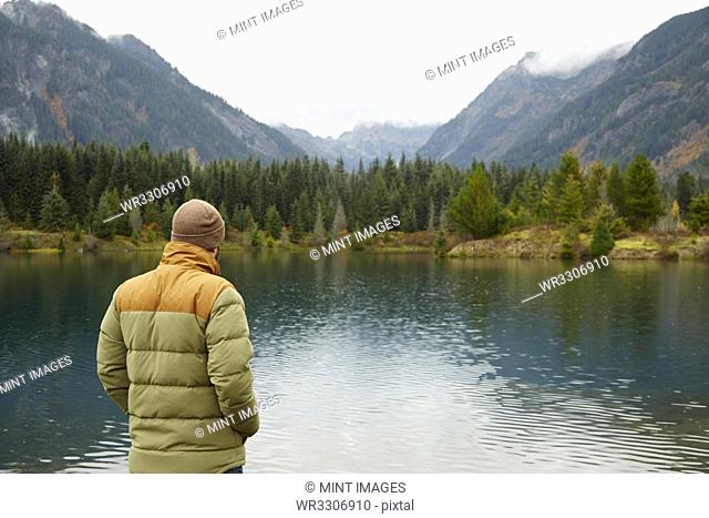 Hiker admiring lake and remote landscape
