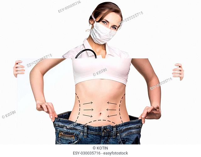 Female doctor holds placard with woman battocks and correction lines on them. Plastic surgery concept