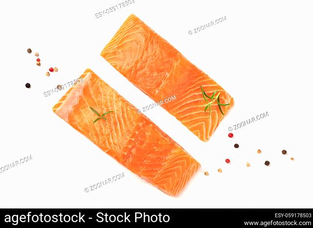 A photo of two slices of salmon with lemon, pepper, and rosemary, on a white background with copy space, overhead photo
