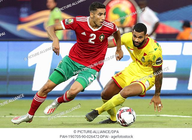 05 July 2019, Egypt, Cairo: Morocco's Achraf Hakimi (L) and Benin's Cebio Soukou battle for the ball during the 2019 Africa Cup of Nations round of 16 soccer...