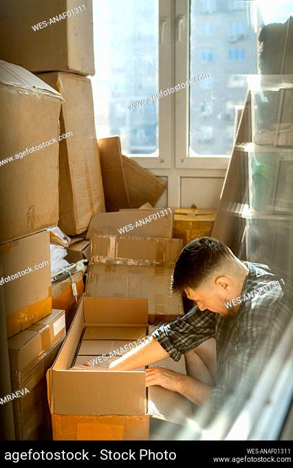 Man packing cardboard boxes for moving house