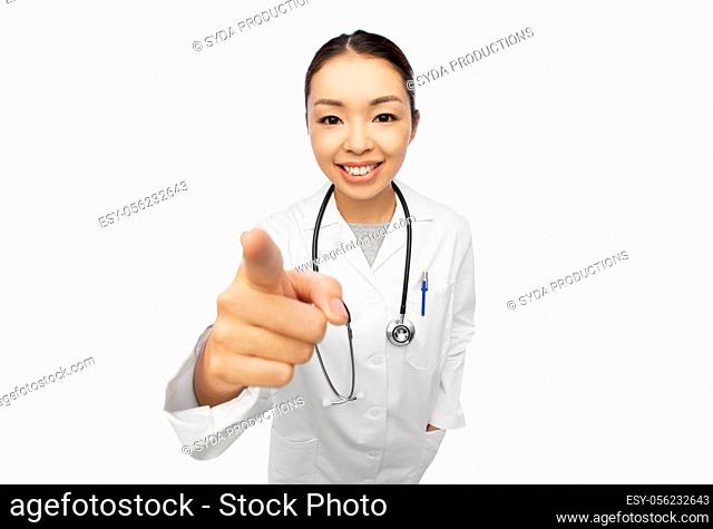 happy asian female doctor pointing to camera