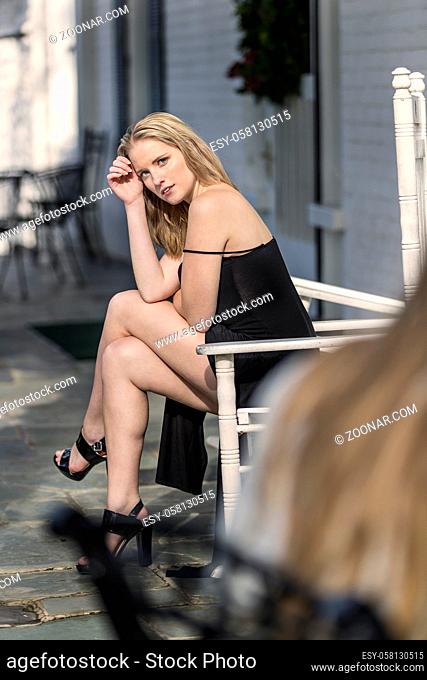 A blonde model posing in an outdoor environment