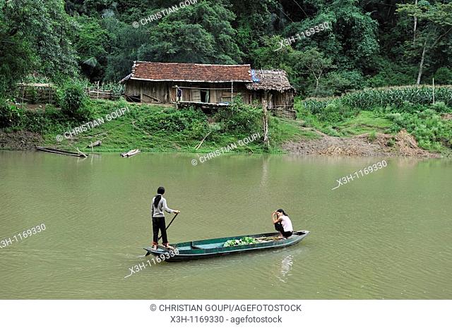 woman driving pirogue on Nang river, Ba Be Lake, Bac Kan province, Northern Vietnam, southeast asia