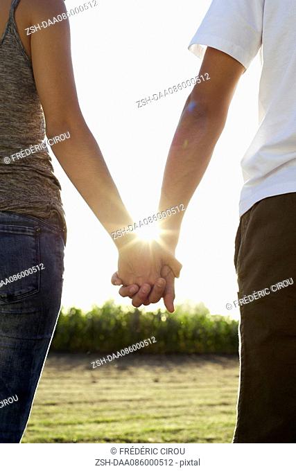 Couple holding hands taking walk together