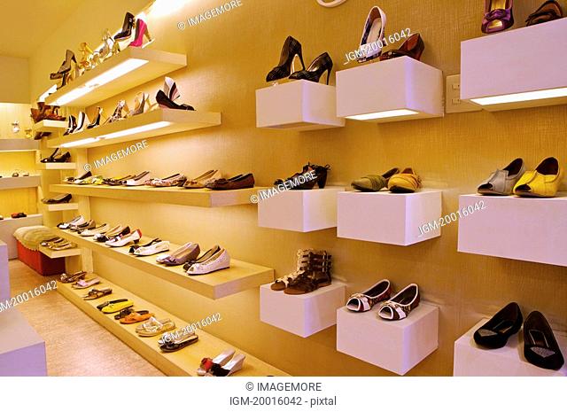 Different kinds of shoes showing on the shelf, Shoe Store