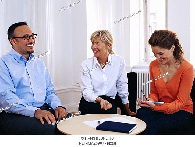 Pair of businesswomen and businessman in meeting