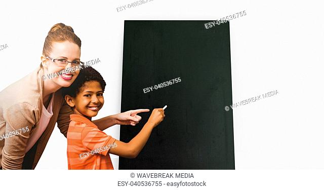 Teacher with pupil writing on board