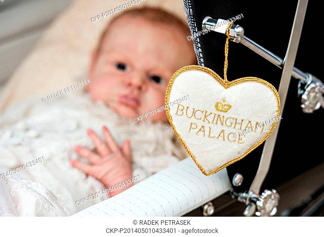 A model shows a doll-baby looking like Prince George, a son of Britain's Prince William and Kate, the Duchess of Cambridge