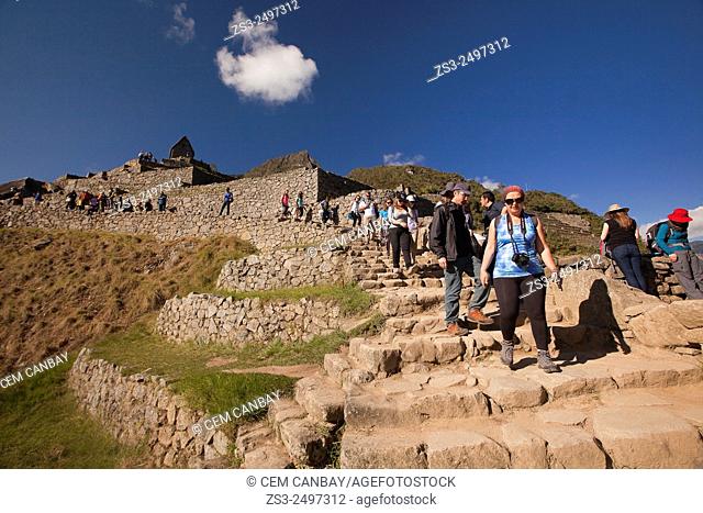 Tourists at the Industrial Sector near the Hut of the Caretaker of the Funerary Rock, Machu Picchu, Cuzco Region, Peru, South America