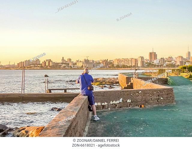 Old Man Taking Photos of Montevideo Coast