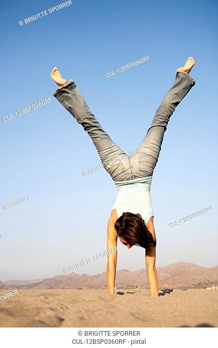 Young Woman Doing Handstand
