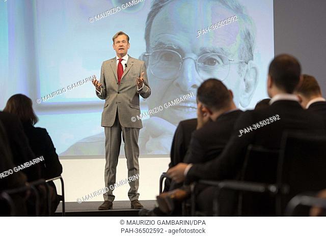 Axel Springer chairman Mathias Doepfner delivers a speech in front of a photo showing former chief editor of the Axel Springer publishing house, Ernst Cramer