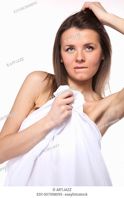 Attractive woman covered in white cloth on white