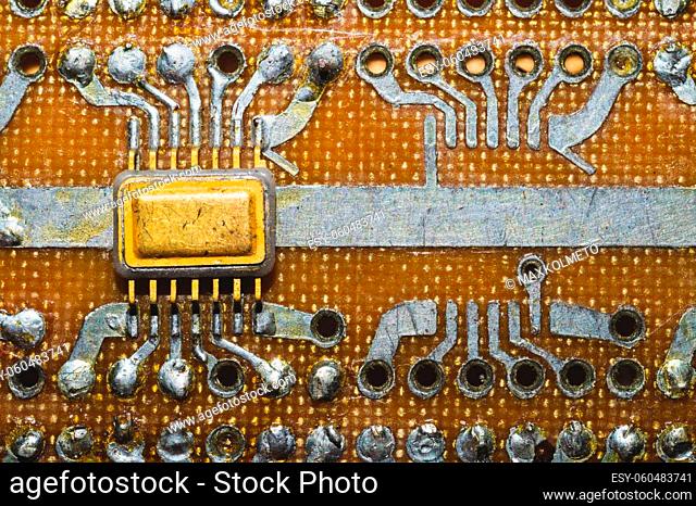Handmade circuit board with microchip. integrated scheme. industrial background. tracks on textolite