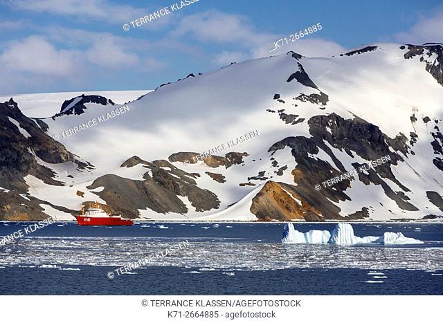 A supply vessel with icebergs and mountains in Admiralty Bay, King George Island, Antarctica