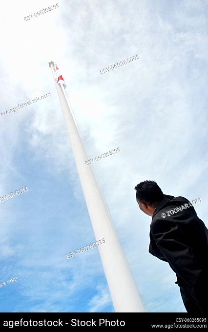 an unidentified man salute the flag of Indonesia