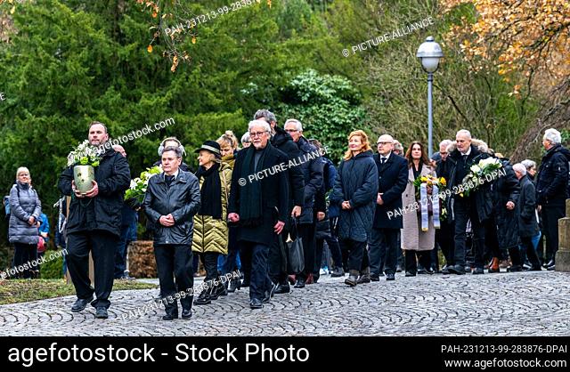 13 December 2023, Saxony, Chemnitz: Gabriele ""Gaby"" Seyfert (center left, with hat), daughter of Jutta Müller, walks with the mourners behind the urn to the...