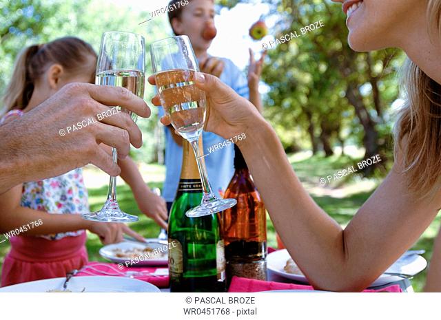 Mid adult woman toasting champagne with a man