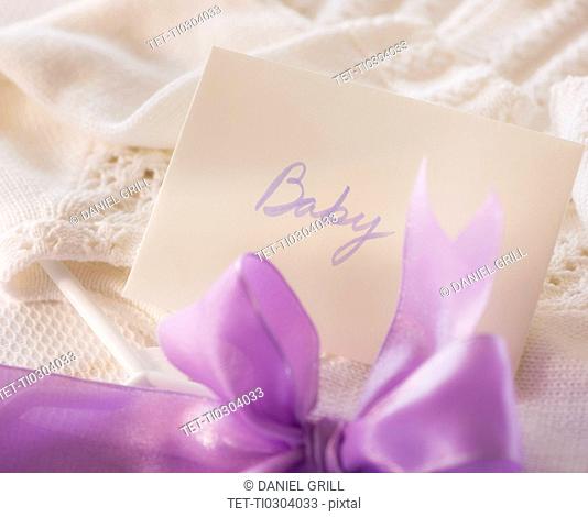Close-up of envelope and purple bow