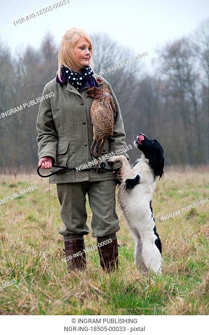 Picker up with her spaniel on a pheasant shoot