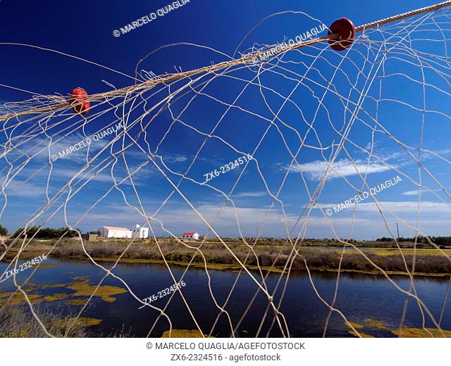 Fishing net at antique Tancada Lagoon saltworks. Ebro River Delta Natural Park, Tarragona province, Catalonia, Spain