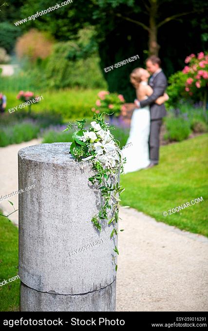wedding details - young marrieds behind a wedding bouquet. High quality photo