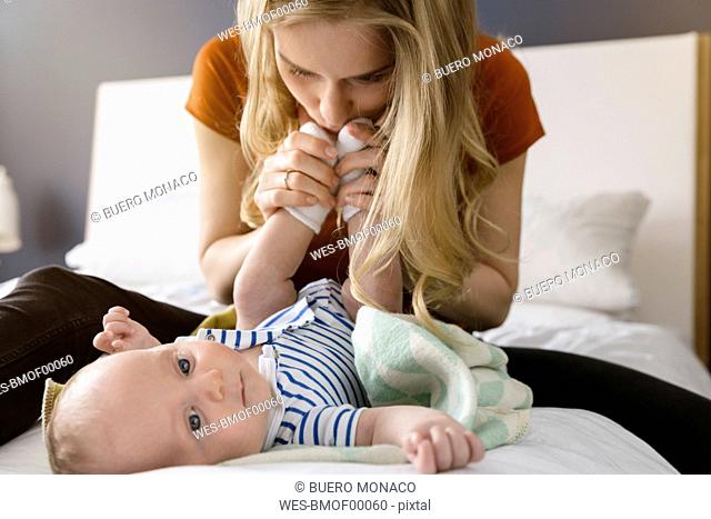 Mother kissing baby boy's feet