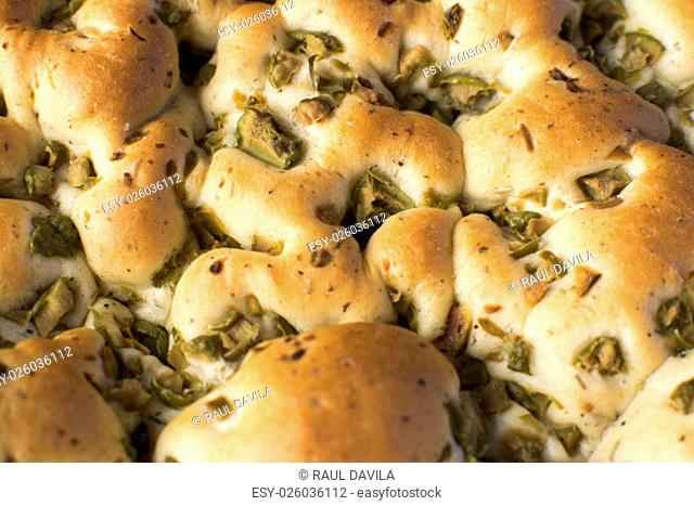 The focaccia is a traditional loaf - bread from the Italian cuisine and this is closely related to the pizza. in this picture you can see the texture and the...