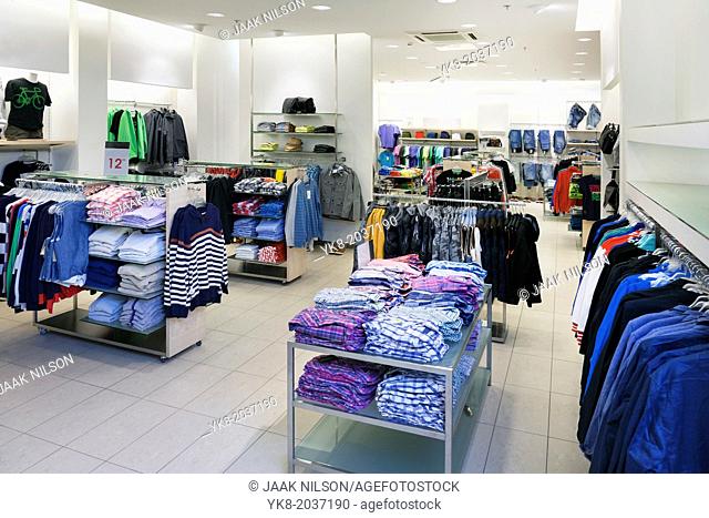 Fashion shop interior with display. Clothing in retail store